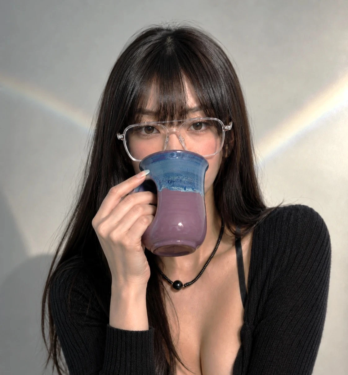 Clay in Motion Handwarmer Mug held by Mei Lin